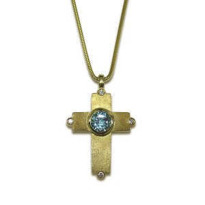 BEJEWELLED LATIN CROSS PENDANT 9ct Satin finish gold cross with Swiss blue topaz and diamond detail, on gold snake chain